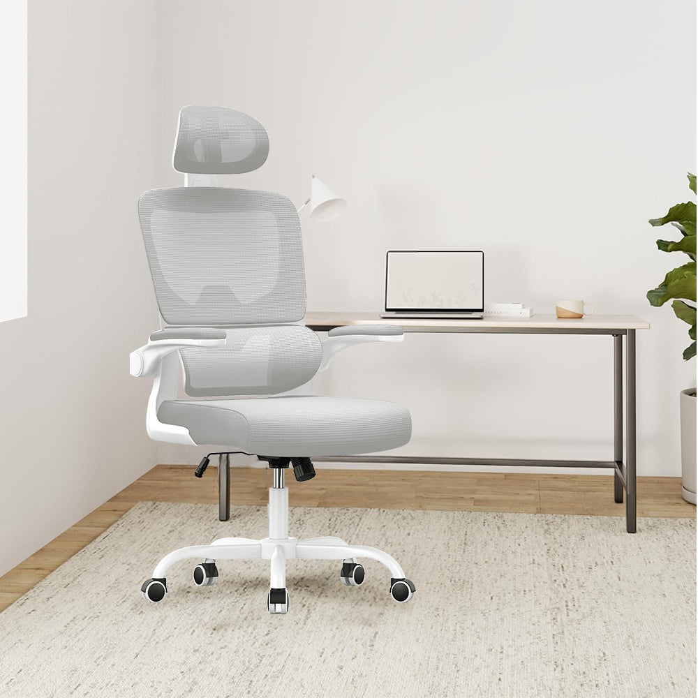 White Ocanvas Office Chair in a minimalistic room with a desk and laptop.