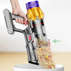 Handheld Aetheros Cordless Vacuum pet food from a bowl with a clear chamber showing collected debris.