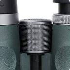 Close-up of a AuraLink Binoculars and black device with a textured cylindrical component.