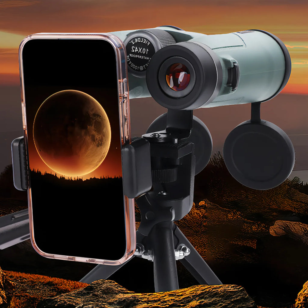 AuraLink Binoculars with smartphone displaying moon image against a sunset landscape