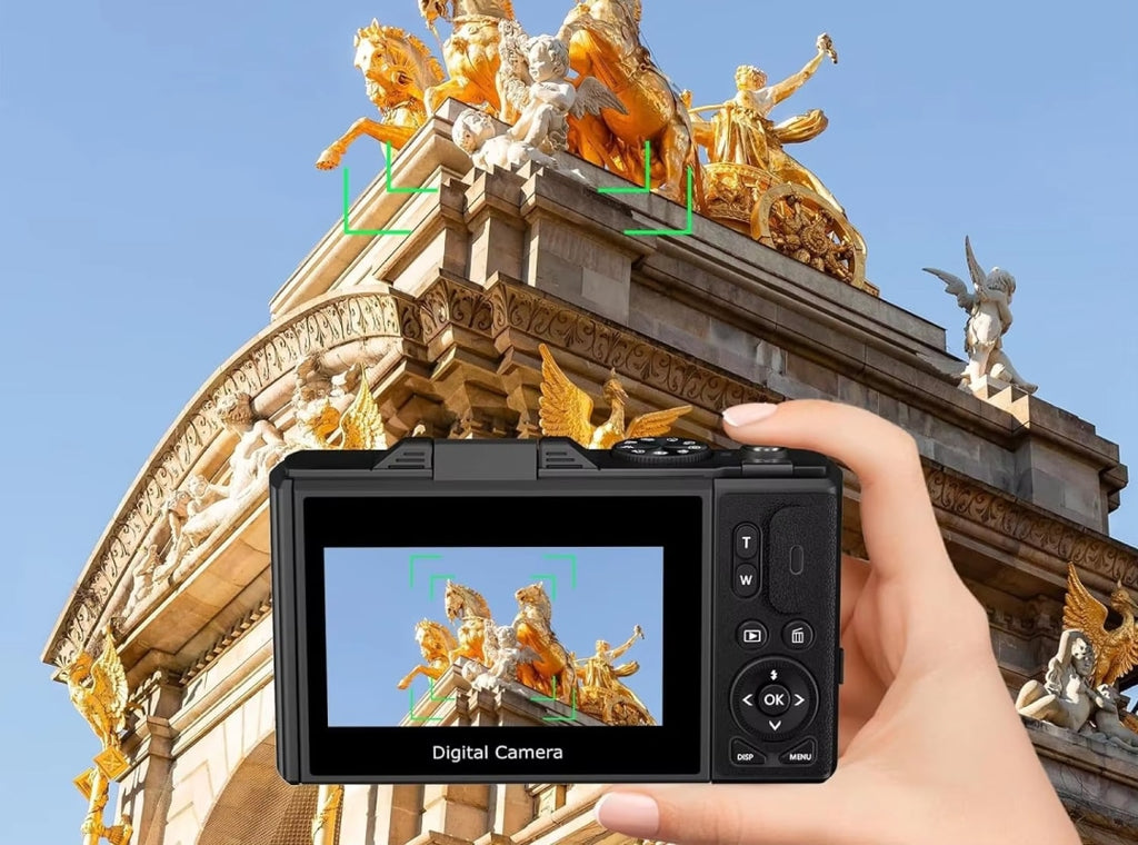 CamZoomy Digital Camera held by a hand with a decorative building in the background