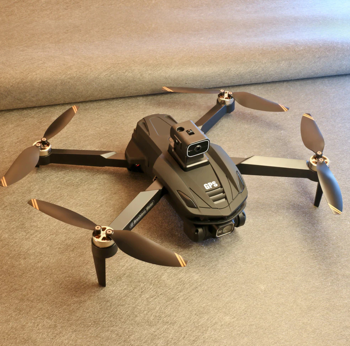 Black Caracen V168 Pro Max drone with propellers on a gray surface