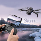 Person controlling a Caracen V168 Pro Max drone with a smartphone, with a snowy landscape in the background.