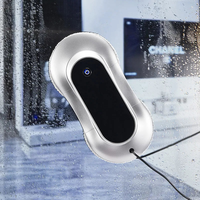 Silver window Comfylife Window Cleaning Robot on a wet glass surface with blurred background