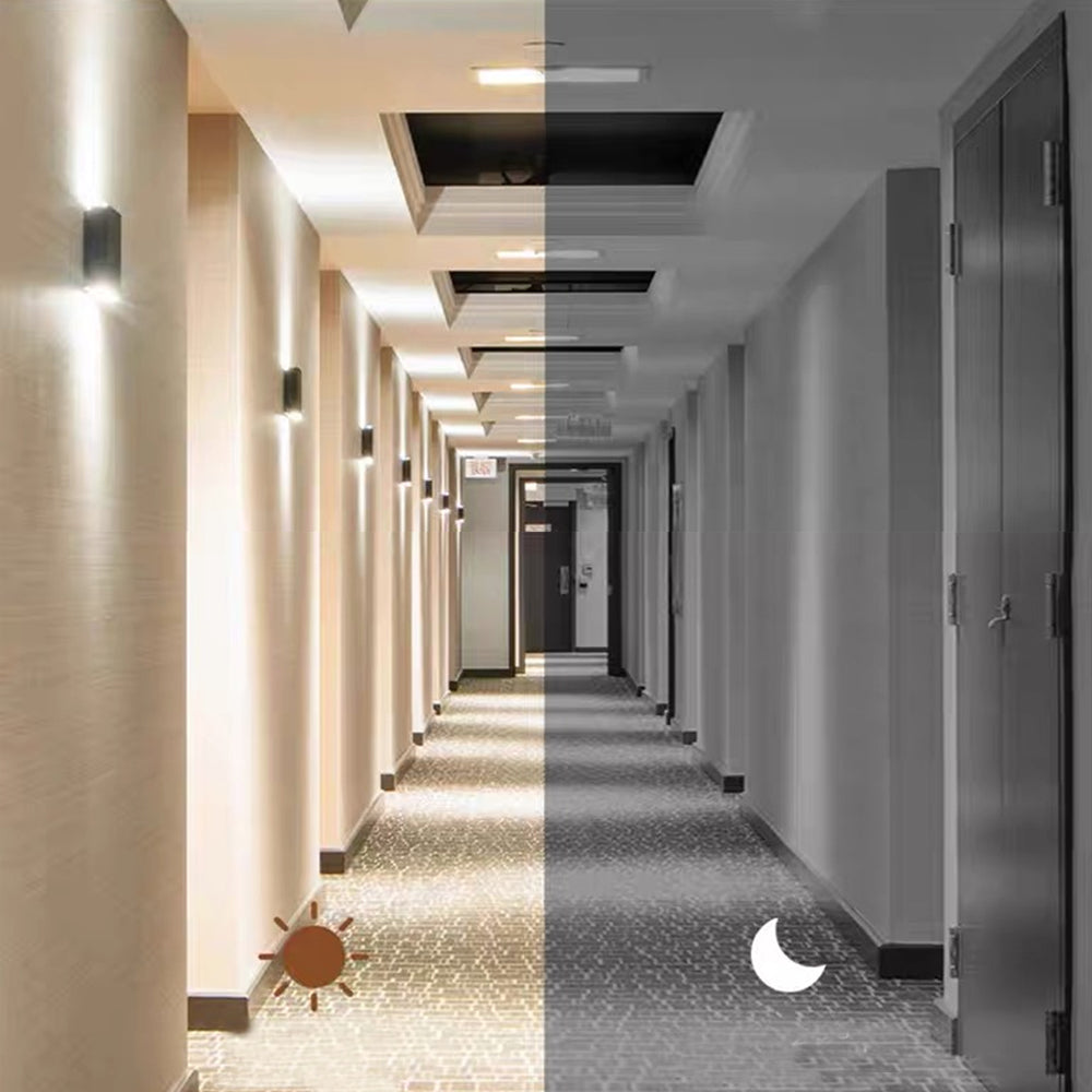 Two halves of a hallway, one lit and one dark, with a sun and moon icon.