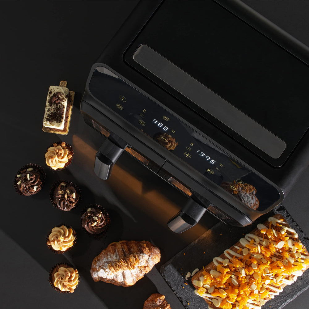 Black Elarvo Air Fryer with various food items on a dark surface