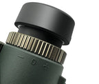 Close-up of a Evoluir Binoculars lens with a focus wheel on a white background
