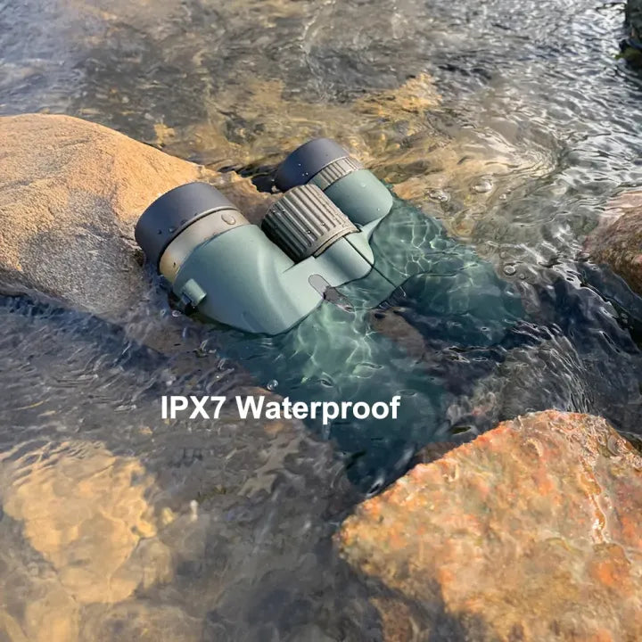 Evoluir Binoculars partially submerged in water with 'IPX7 Waterproof' text displayed.