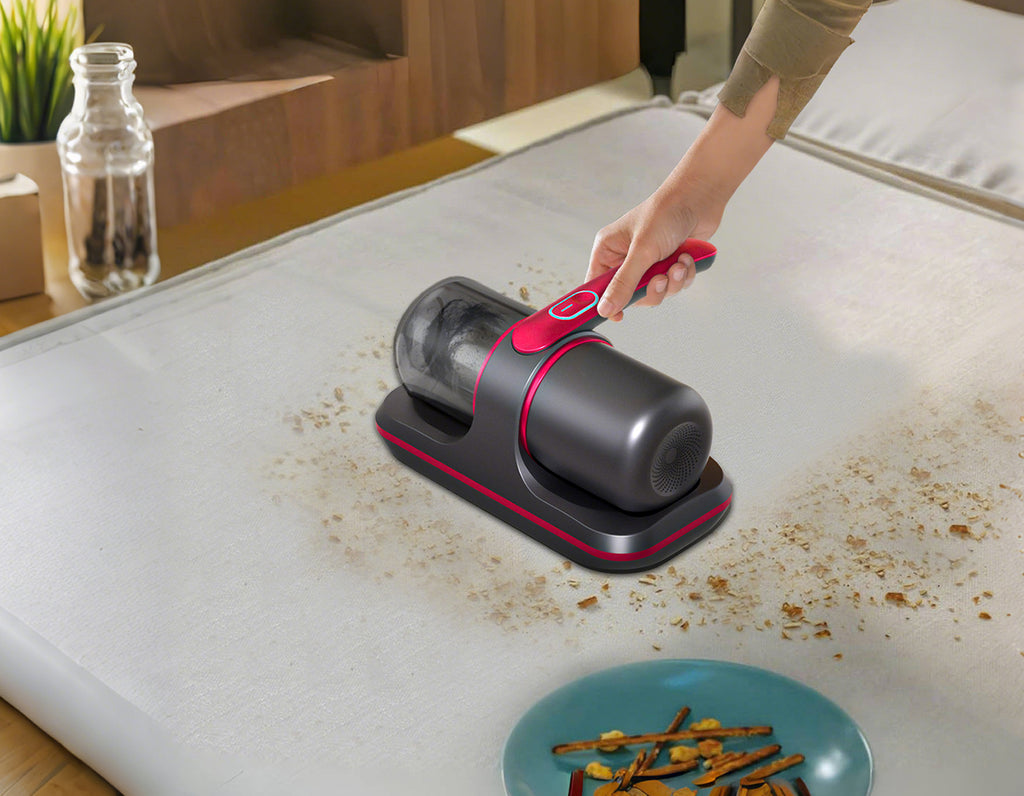 Person using a Fracix Mattress Vacuum on a table with food residue.