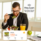Man eating a salad with nutritional information displayed, sitting at a table with a Fracix AI Smart Glasses of orange juice and an apple.