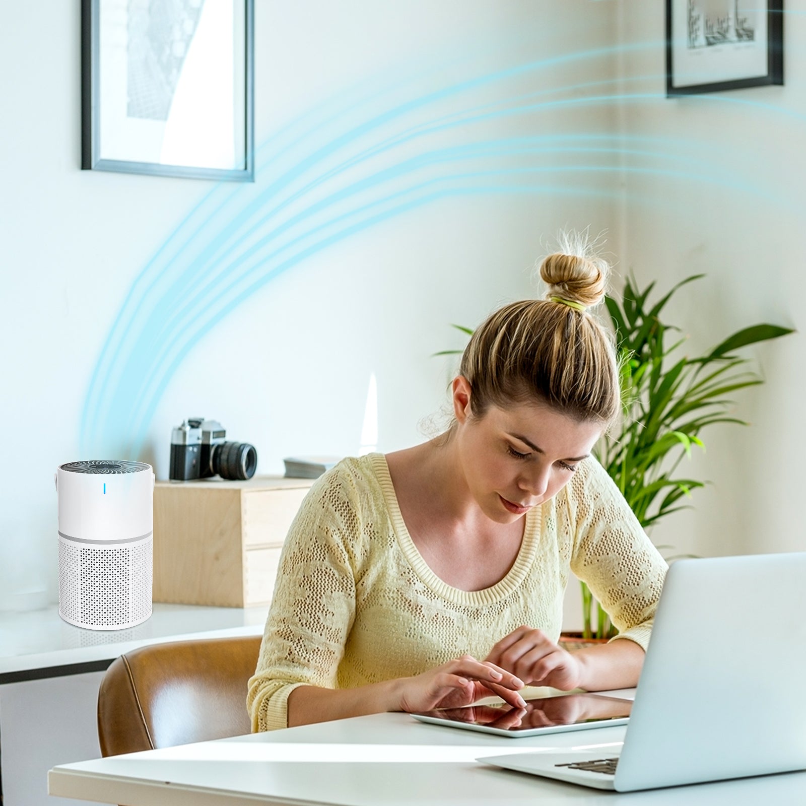 woman using tablet next to Klarity Air Purifier 