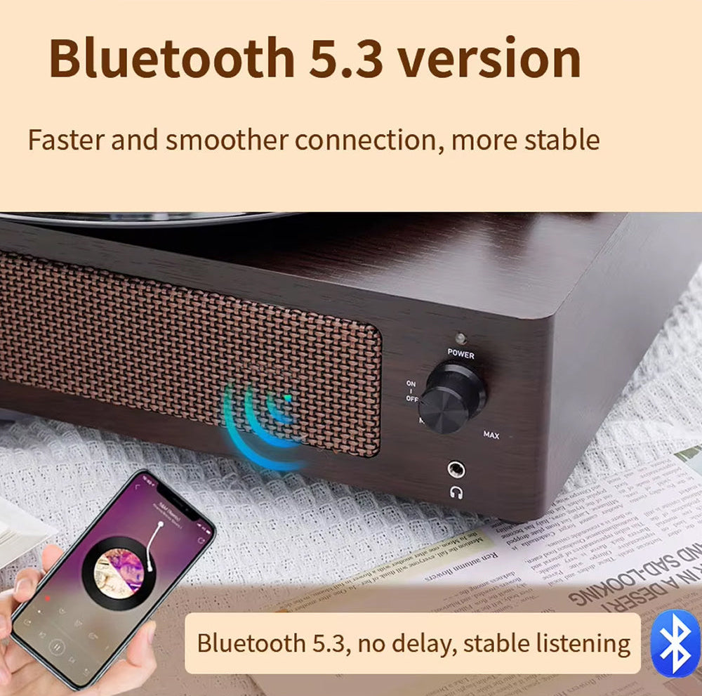 Black Bluetooth Klarity Record Player with smartphone showing music app on a newspaper background, emphasizing Bluetooth 5.3 connection.