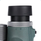 Close-up of a Kozenix Binoculars with a focus on the eyecup and control buttons on a white background.