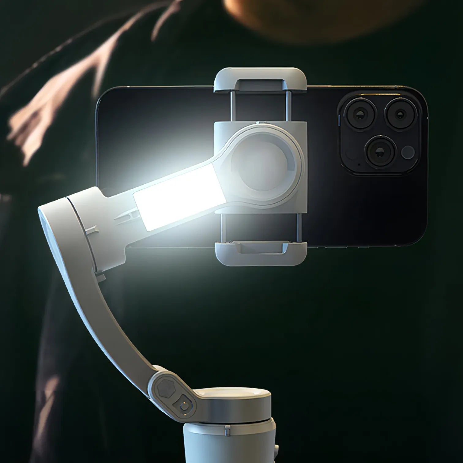 Smartphone with a mounted light and Kozenix Gimbal on a dark background