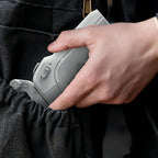 Hand holding a small Kozenix Gimbal device against a dark background