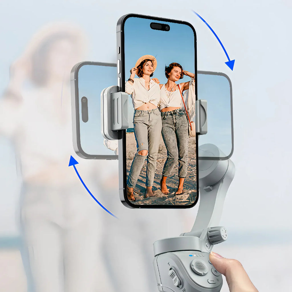 Hand holding a smartphone with a phone Kozenix Gimbal displaying two women on screen against a blurred background