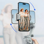 Hand holding a smartphone with a phone Kozenix Gimbal displaying two women on screen against a blurred background
