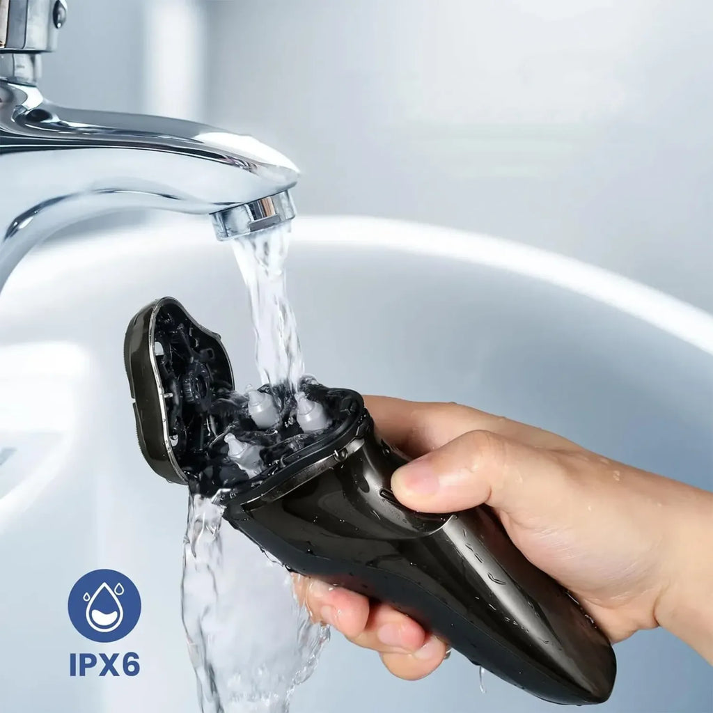 Hand holding a black Nordzens Shaver under running water from a faucet, with IPX6 rating logo.