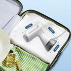 A white Orivana Handheld Steamer with a transparent dust cup displayed inside an open suitcase, with overlaid dimension labels showing 6.10m, 9.