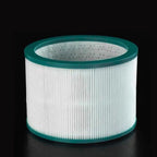 Round air filter for Purethcare air purifierwith green rim on a black background 