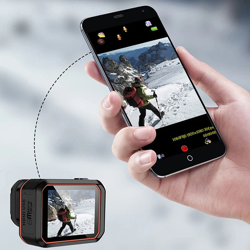 Hand holding a smartphone with a ReefiSnap Action Camera app open, showing a snowy landscape and person with a backpack.