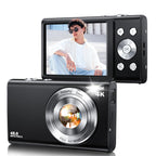 ShotyReal Digital Camera with screen displaying a person, memory card, batteries, and additional camera on a white background