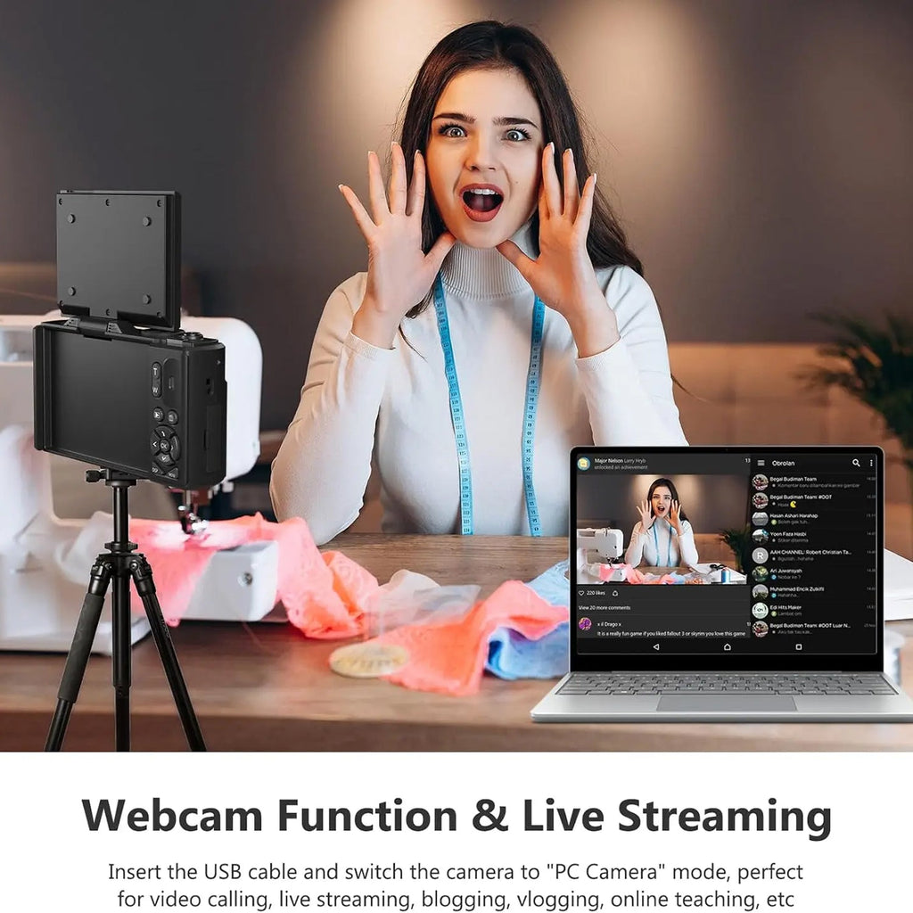 Woman using a webcam setup with a laptop displaying a live stream, on a wooden table.