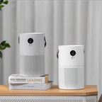 Two white cylindrical portable SkyPhis Air Purifier with black circular digital displays and hanging handles, shown on a wooden table with books in the background against a soft curtain backdrop.