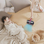 Person using a Smaven Mattress Vacuum Cleaner tool on a bed with a child and two cats.