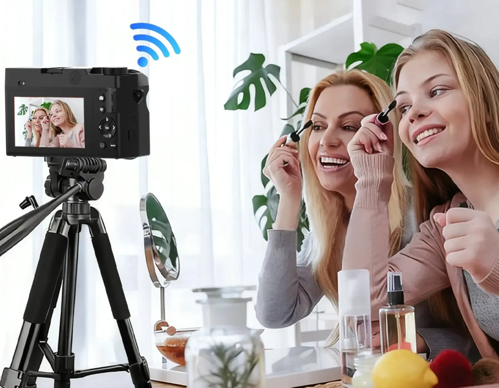 Two women applying makeup in front of a Smaven Roam D7 Digital Camera on a tripod, with a Wi-Fi symbol indicating remote control.