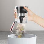 Hand using a clear and black pepper grinder to sprinkle pepper into a white container.