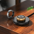 Thurgoo Smart Ring and base on a wooden surface